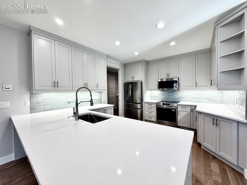 3155 Promise Point Colorado Springs, CO 80921 - Photo 8 of 26 a kitchen with stainless steel appliances a sink stove and cabinets