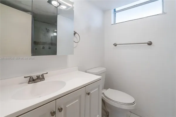 a bathroom with a sink toilet and vanity