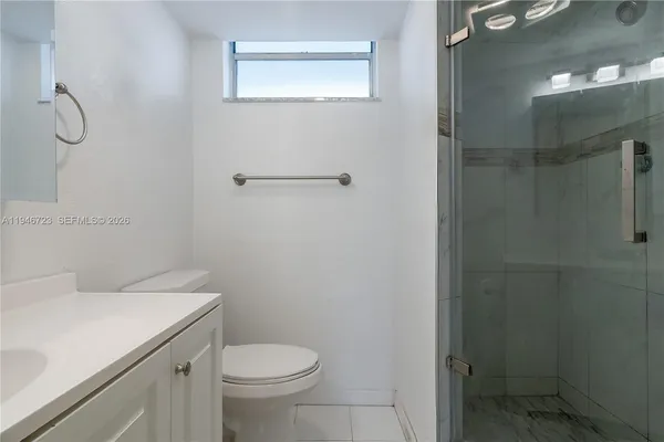a white toilet sitting next to a bathroom sink