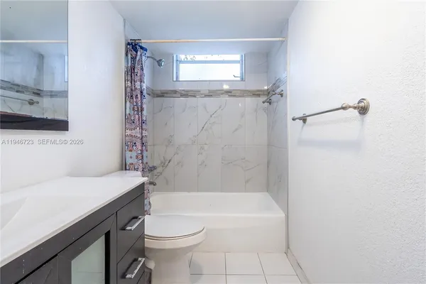 a bathroom with a sink a toilet and a bathtub