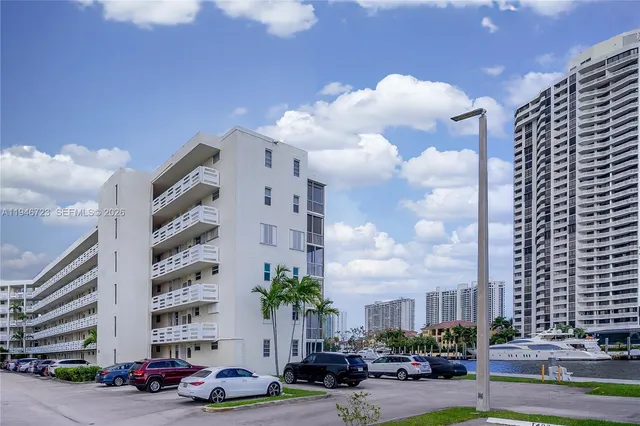 a cars parked in front of a tall building