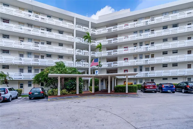 a view of building with cars parked