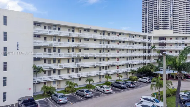 a view of a tall building with many windows and potted plants
