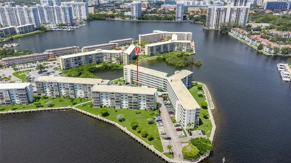 a balcony with couple of cars parked on the road
