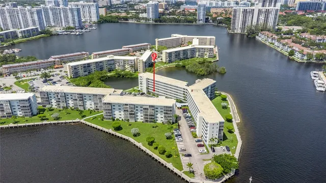a balcony with couple of cars parked on the road