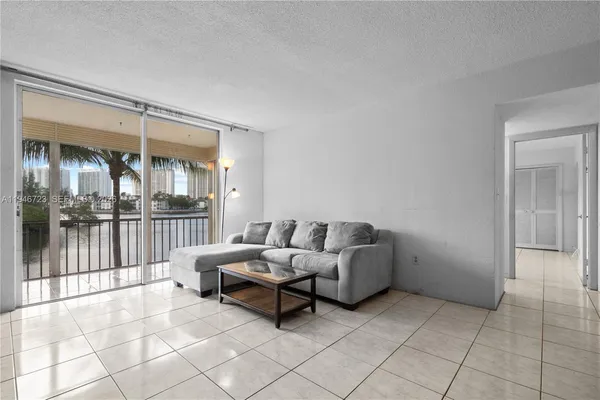 a living room with furniture and view of wooden floor