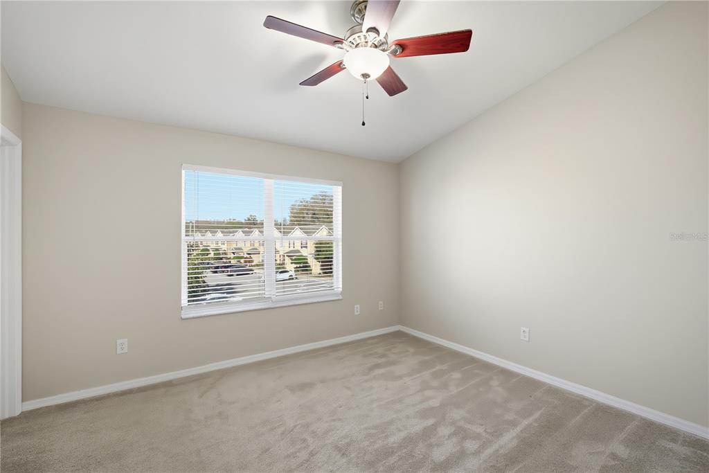 1417 Sedgwick Drive Wesley Chapel, FL 33543 - Photo 12 of 22 an empty room with a window and a fan