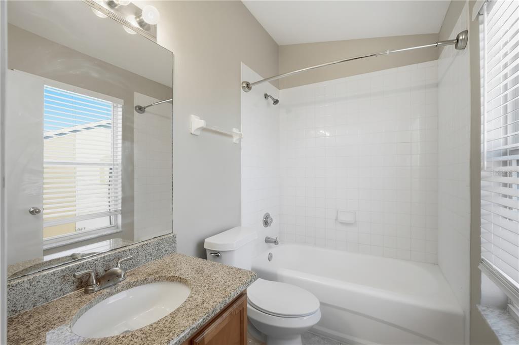 1417 Sedgwick Drive Wesley Chapel, FL 33543 - Photo 15 of 22 a bathroom with a granite countertop sink toilet tub and shower