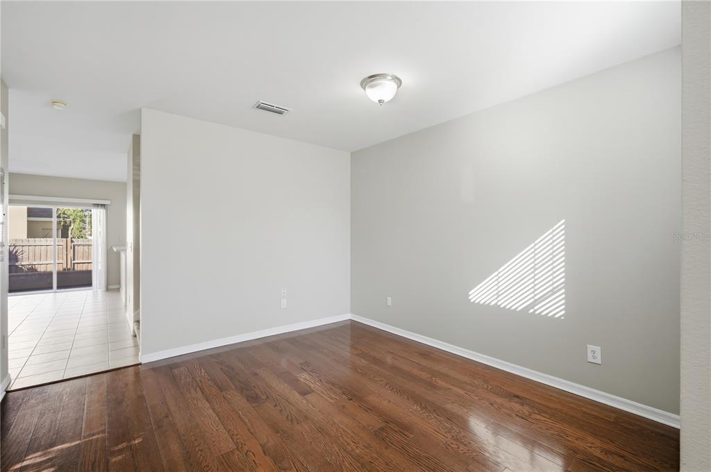 1417 Sedgwick Drive Wesley Chapel, FL 33543 - Photo 2 of 22 an empty room with wooden floor and windows