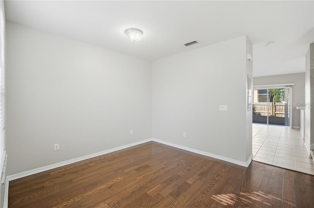 1417 Sedgwick Drive Wesley Chapel, FL 33543 - Photo 3 of 22 a view of an empty room with wooden floor and a window