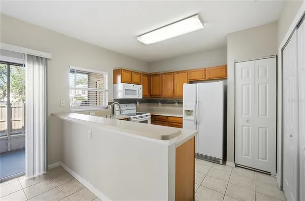 a kitchen with stainless steel appliances granite countertop a refrigerator and a stove