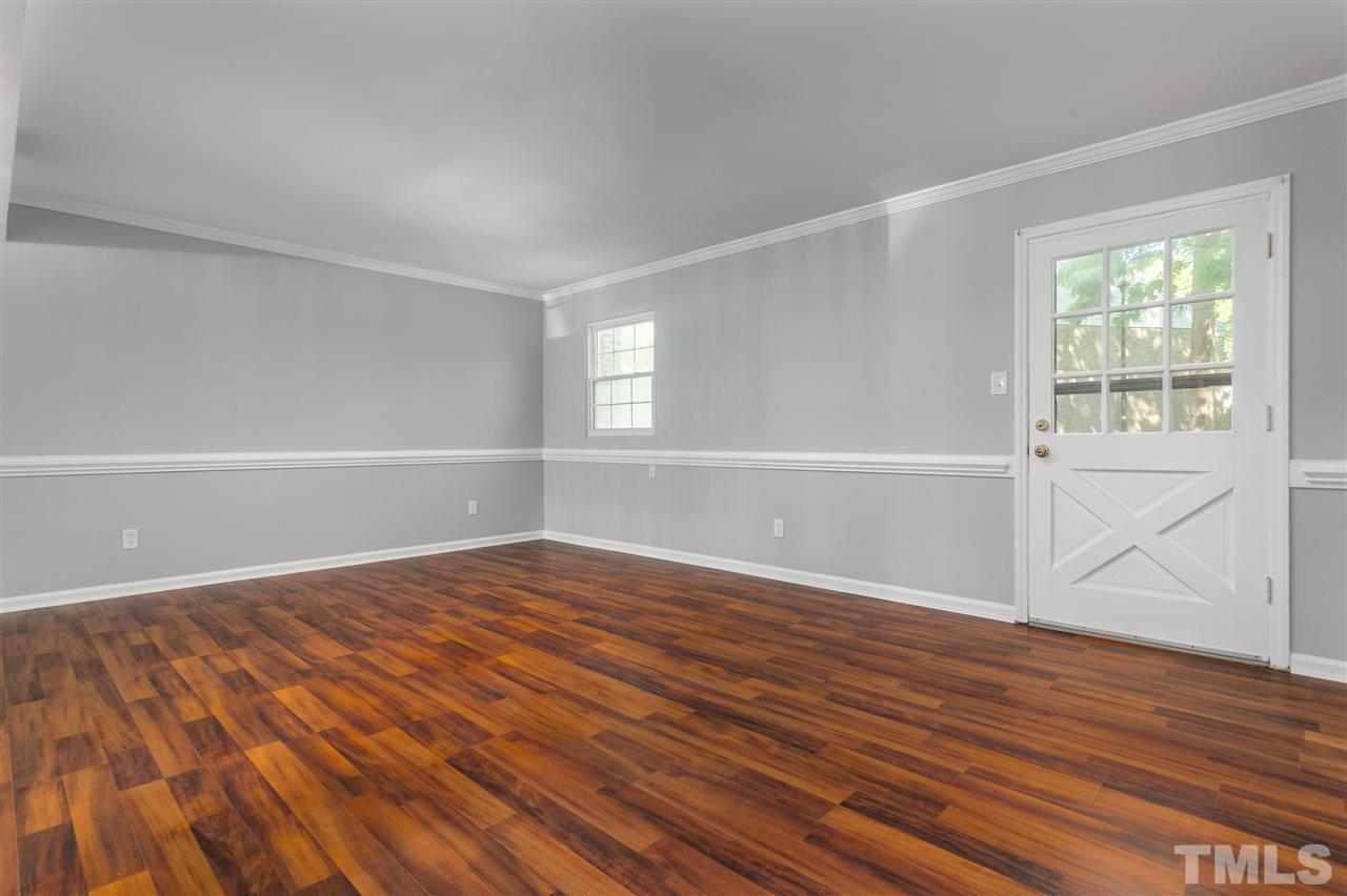 6453 New Market Way, Unit 6453 Raleigh, NC 27615 - Photo 10 of 30 Back door off the living room leads to a nice deck, just the right size for enjoying a glass of wine after dinner!