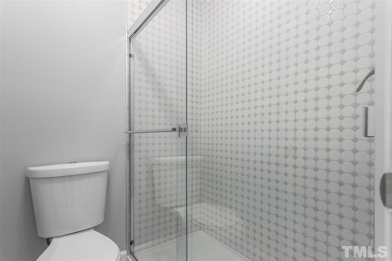 6453 New Market Way, Unit 6453 Raleigh, NC 27615 - Photo 7 of 30 Love the look of this tile behind the glass shower doors!