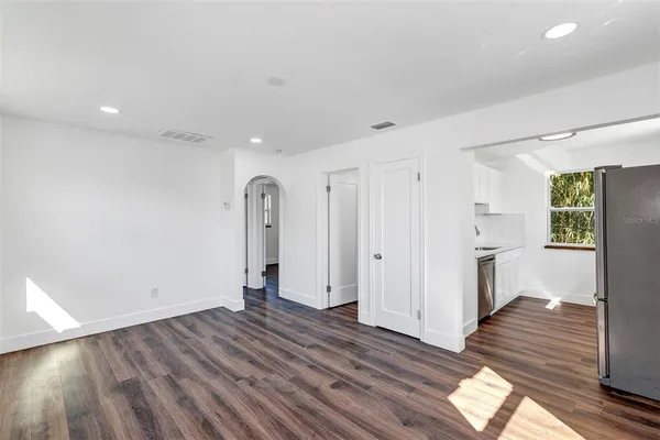 a kitchen with a refrigerator and a window