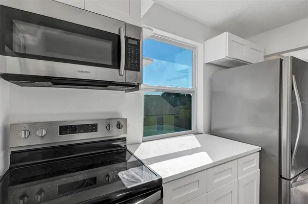 a kitchen with white cabinets and a sink