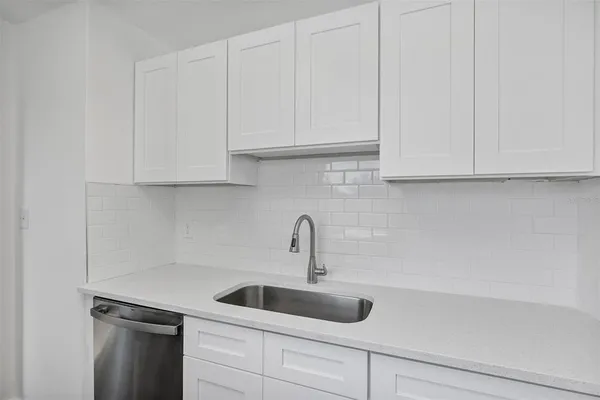 a bathroom with a sink a toilet and a window