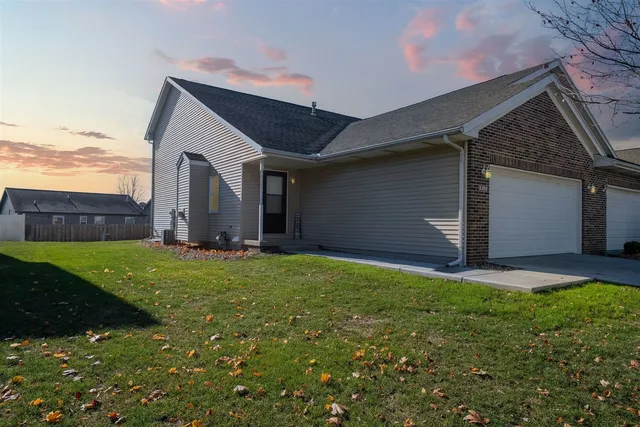 a front view of house with yard and outdoor seating