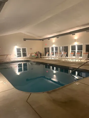 a room with gym equipment and large mirror