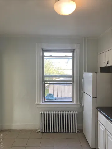 a kitchen with a refrigerator and a window