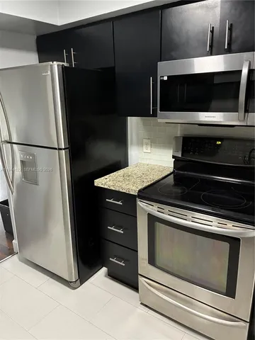 a kitchen with appliances and cabinets