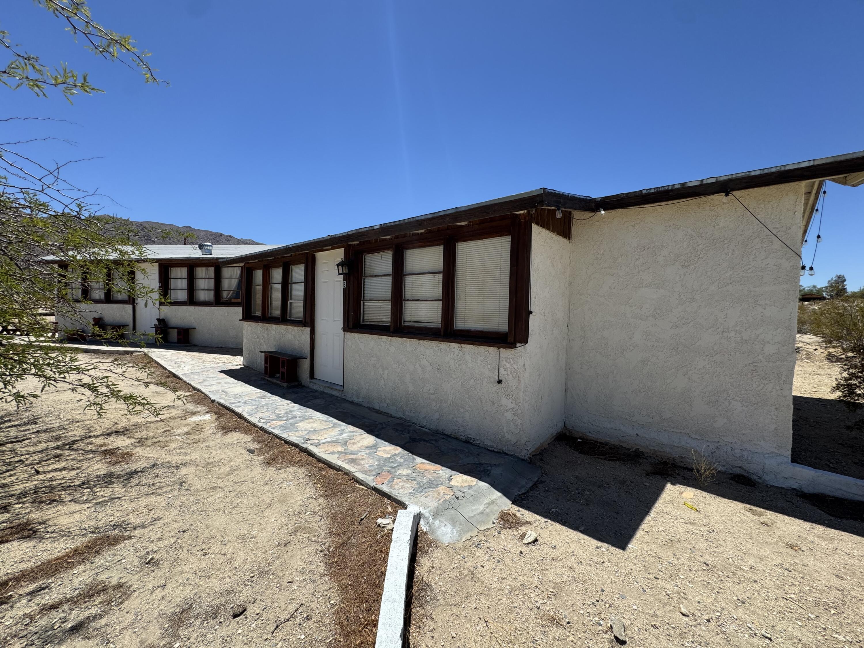 73392 Sullivan Road Twentynine Palms, CA 92277 - Photo 11 of 29 a view of a house with a roof deck