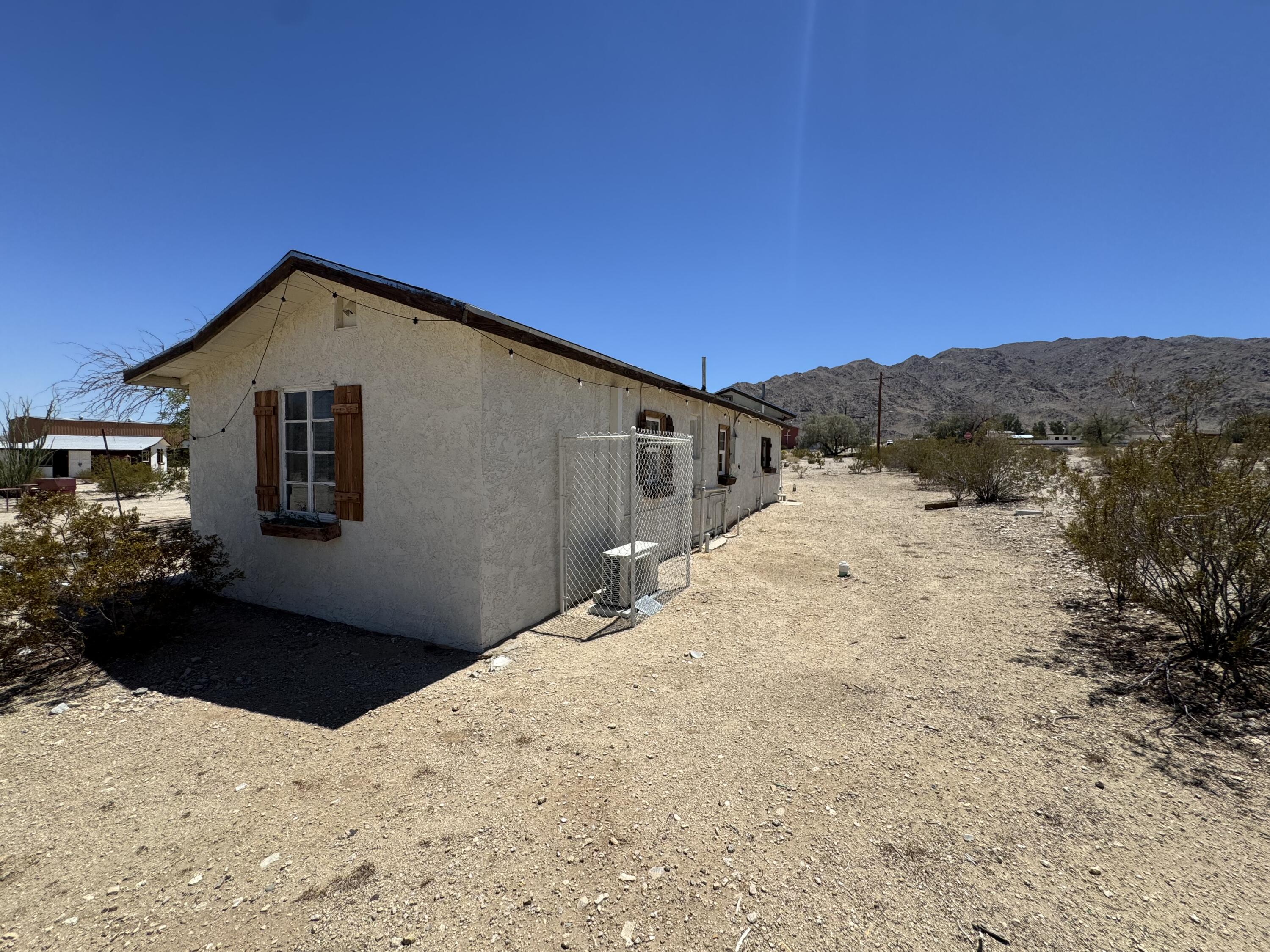 73392 Sullivan Road Twentynine Palms, CA 92277 - Photo 12 of 29 a front view of a house with a yard