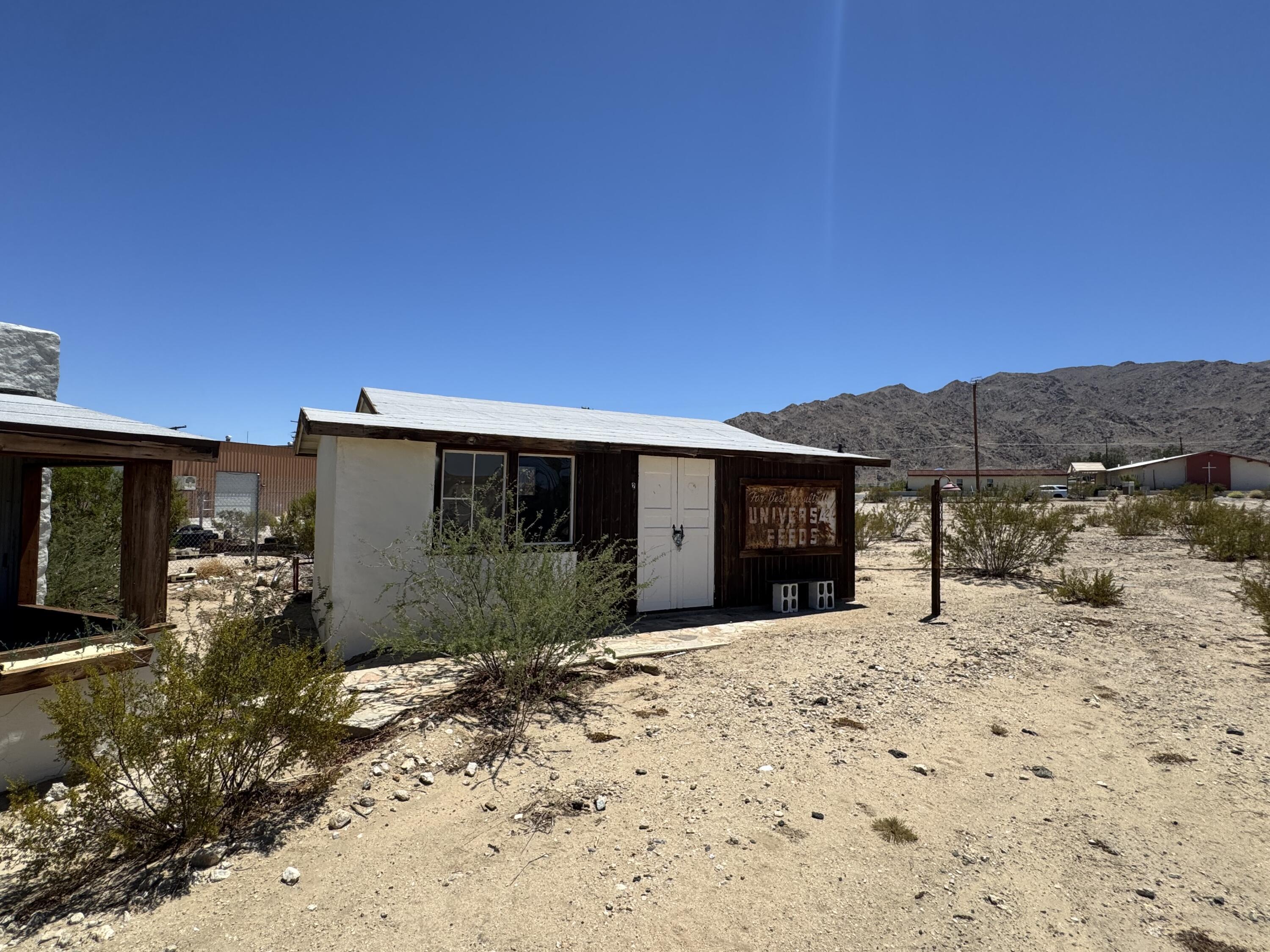 73392 Sullivan Road Twentynine Palms, CA 92277 - Photo 18 of 29 a front view of a house with a yard and garage