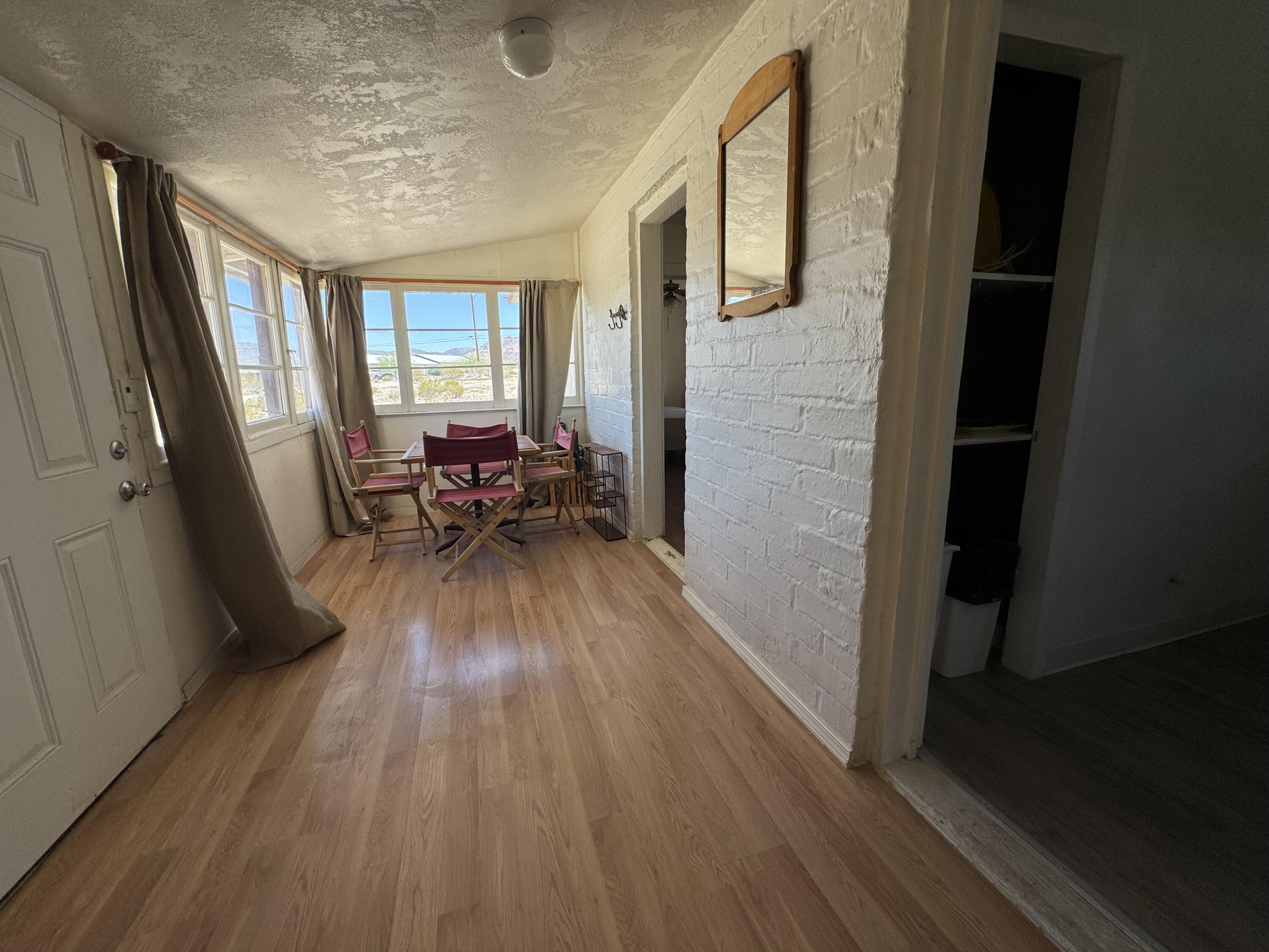 73392 Sullivan Road Twentynine Palms, CA 92277 - Photo 25 of 29 a living room with furniture and a wooden floor