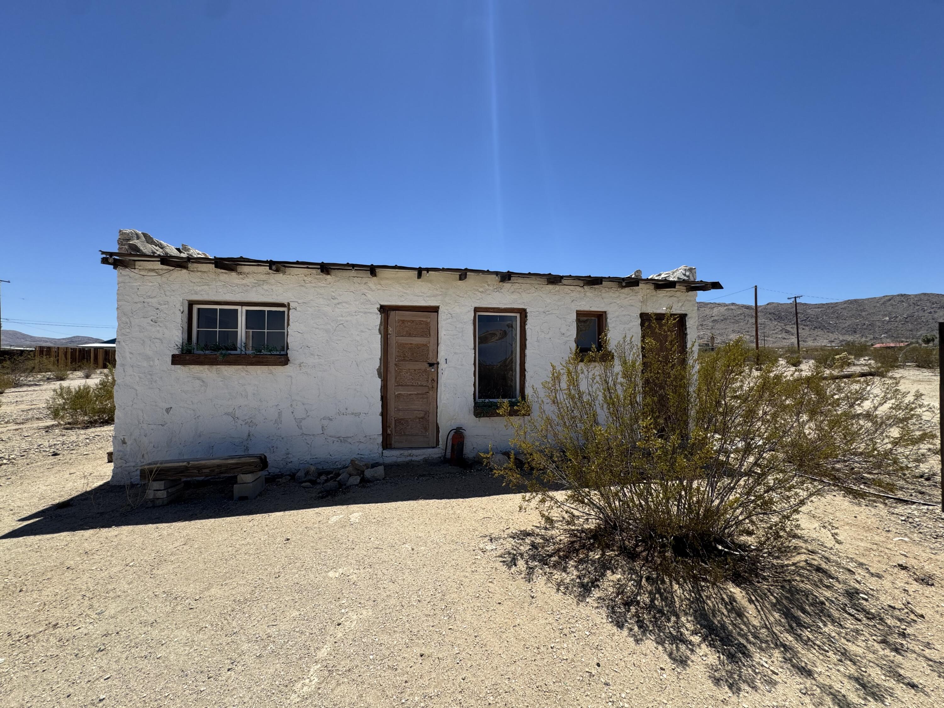 73392 Sullivan Road Twentynine Palms, CA 92277 - Photo 28 of 29 a view of a house with a backyard
