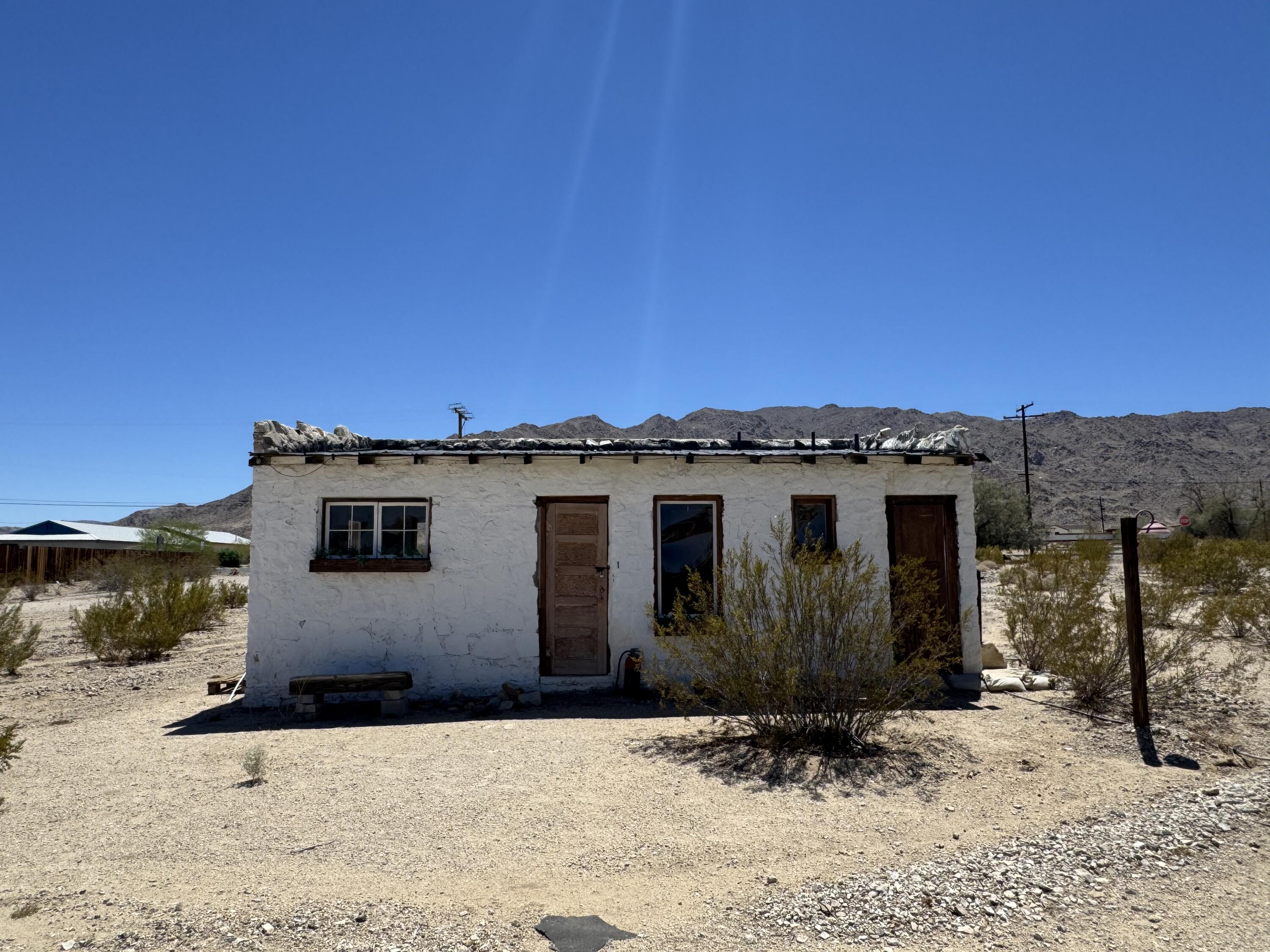 73392 Sullivan Road Twentynine Palms, CA 92277 - Photo 7 of 29 a front view of a house with a yard