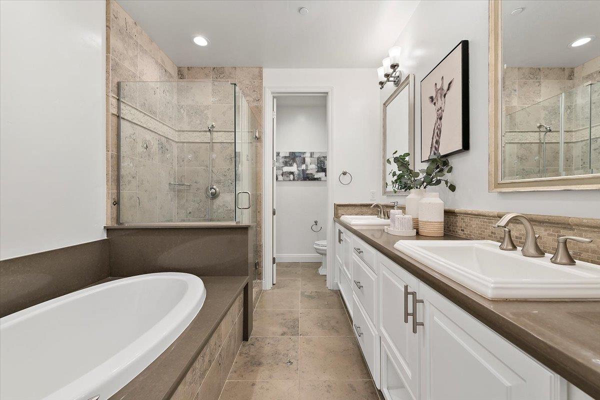 3003 Marcelli Circle Los Altos, CA 94022 - Photo 20 of 21 a bathroom with a double vanity sink a mirror and a bathtub