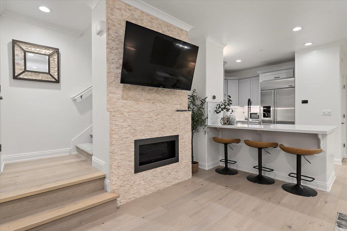 3003 Marcelli Circle Los Altos, CA 94022 - Photo 3 of 21 a living room with furniture a flat screen tv and a fireplace
