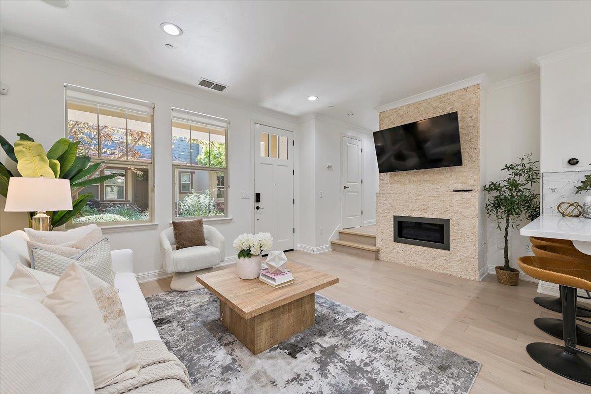 3003 Marcelli Circle Los Altos, CA 94022 - Photo 5 of 21 a living room with furniture a fireplace and a flat screen tv