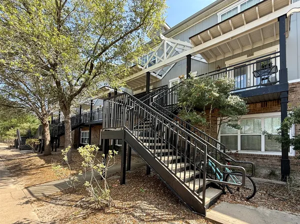 a view of a building with a small yard