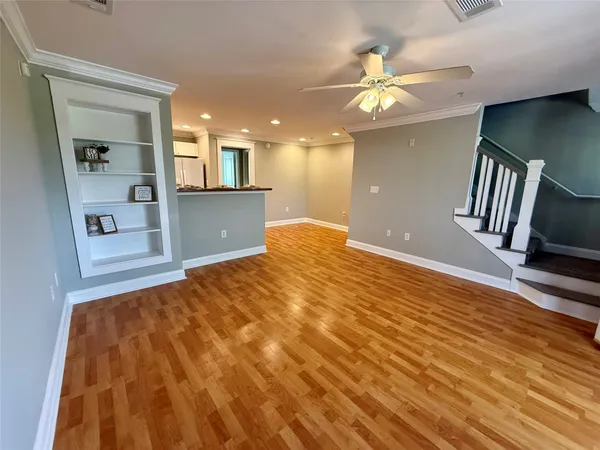 a view of livingroom with hardwood floor and a ceiling fan