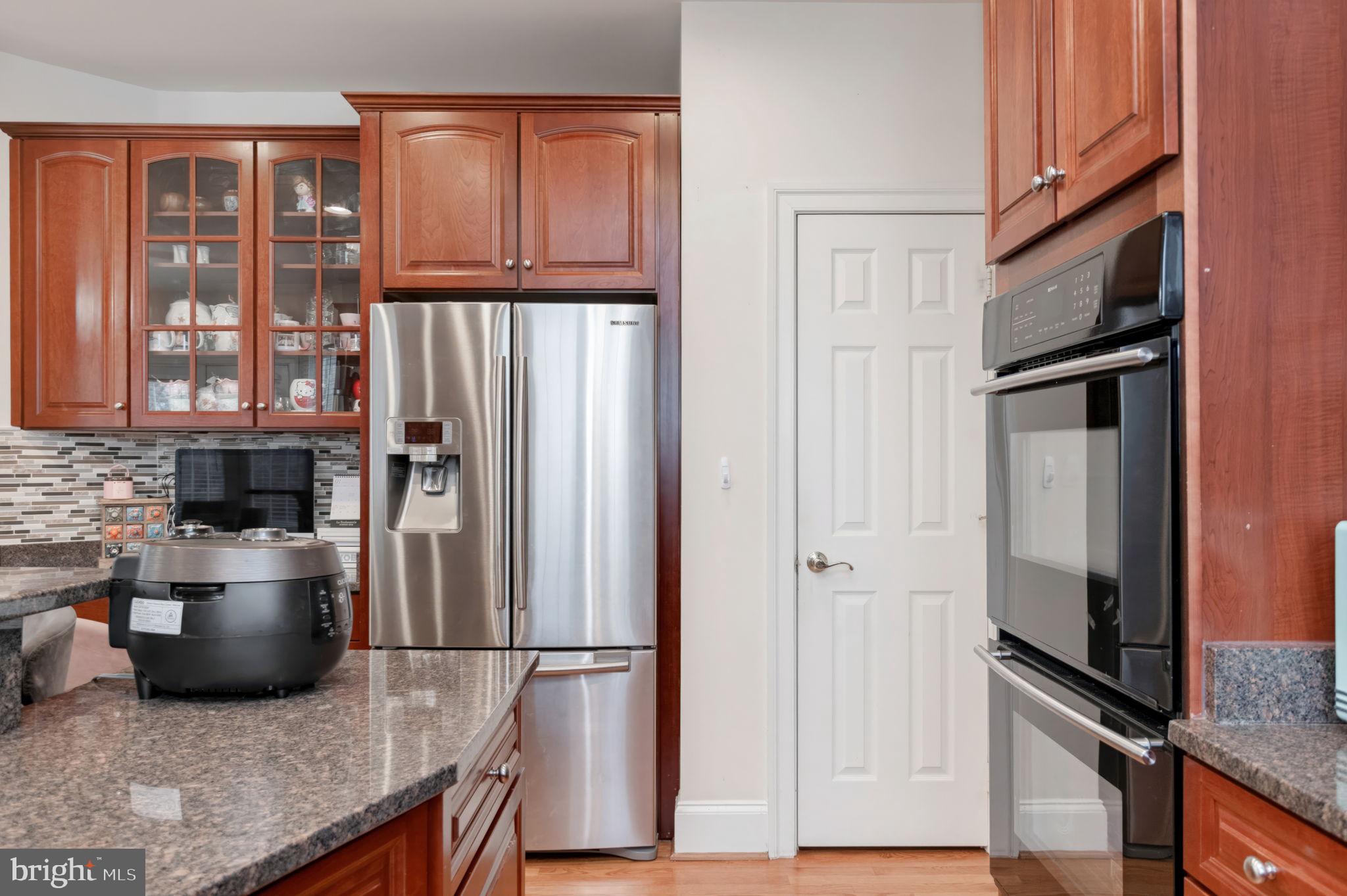 11375 Harding Road Laurel, MD 20723 - Photo 13 of 40 a kitchen with stainless steel appliances granite countertop a refrigerator and a stove