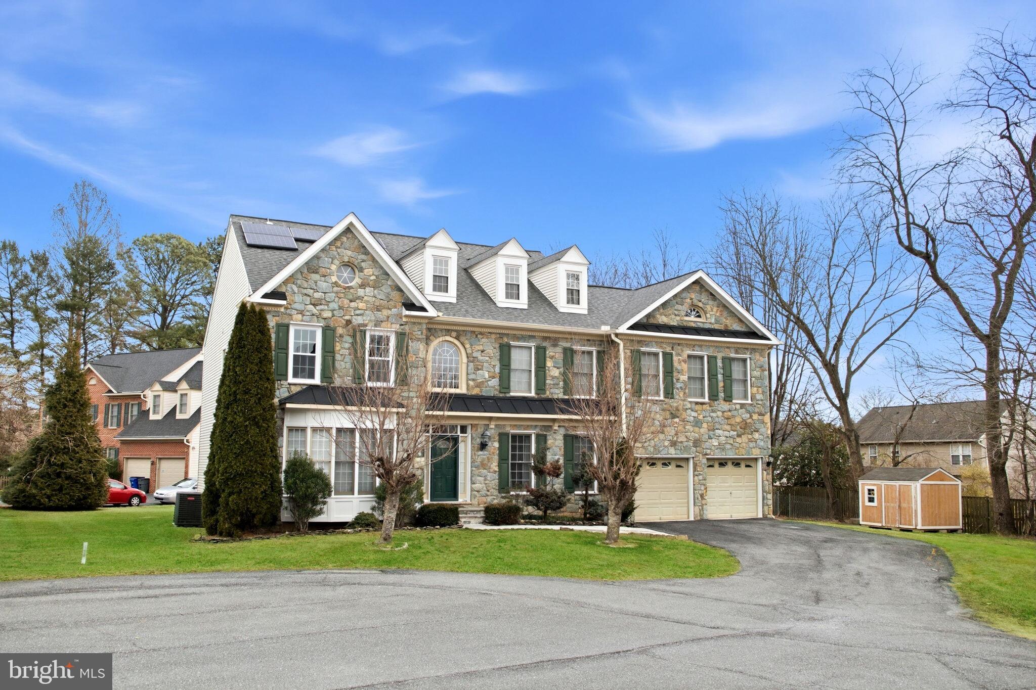 11375 Harding Road Laurel, MD 20723 - Photo 2 of 40 a view of a big house with a yard and large trees