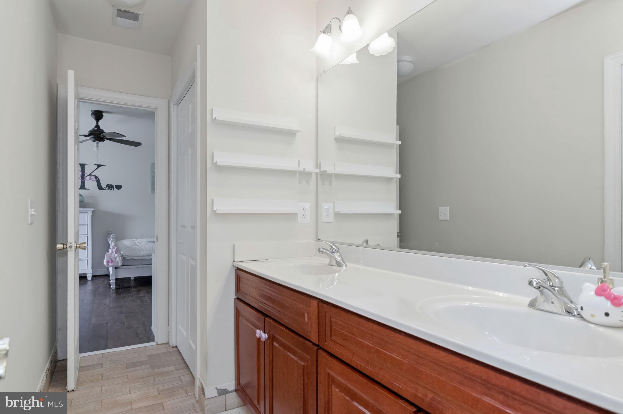 11375 Harding Road Laurel, MD 20723 - Photo 29 of 40 a en suite bathroom with a sink and a mirror