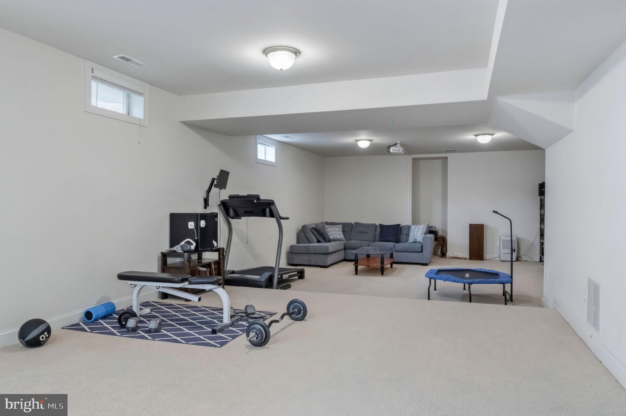 11375 Harding Road Laurel, MD 20723 - Photo 34 of 40 a room with gym equipment and view of living room