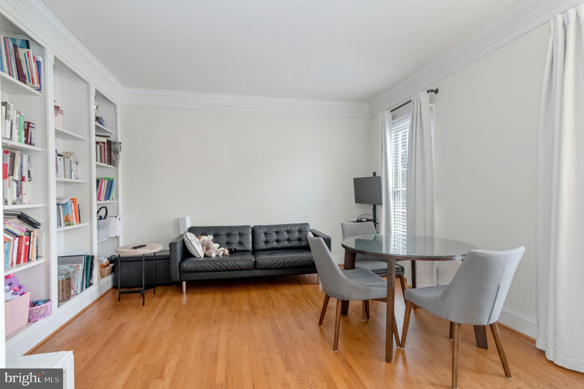11375 Harding Road Laurel, MD 20723 - Photo 8 of 40 a living room with furniture and a book shelf
