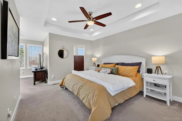 a bedroom with a large bed and a chandelier