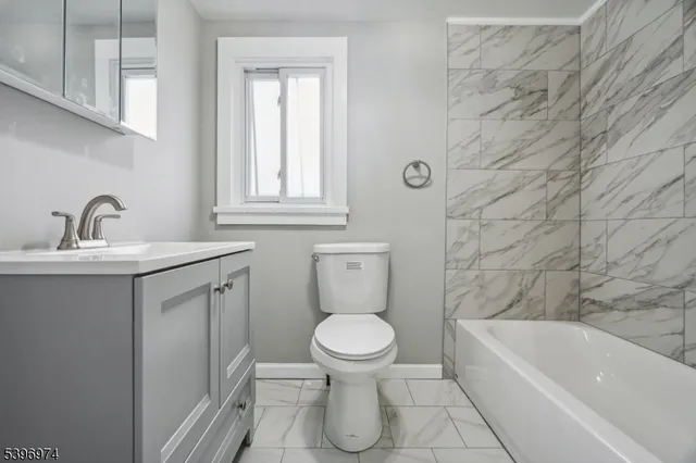 a bathroom with a sink a toilet and bathtub