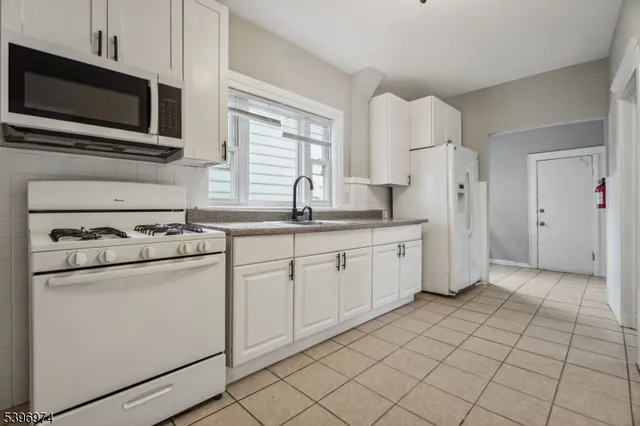 a kitchen with a sink stove and microwave
