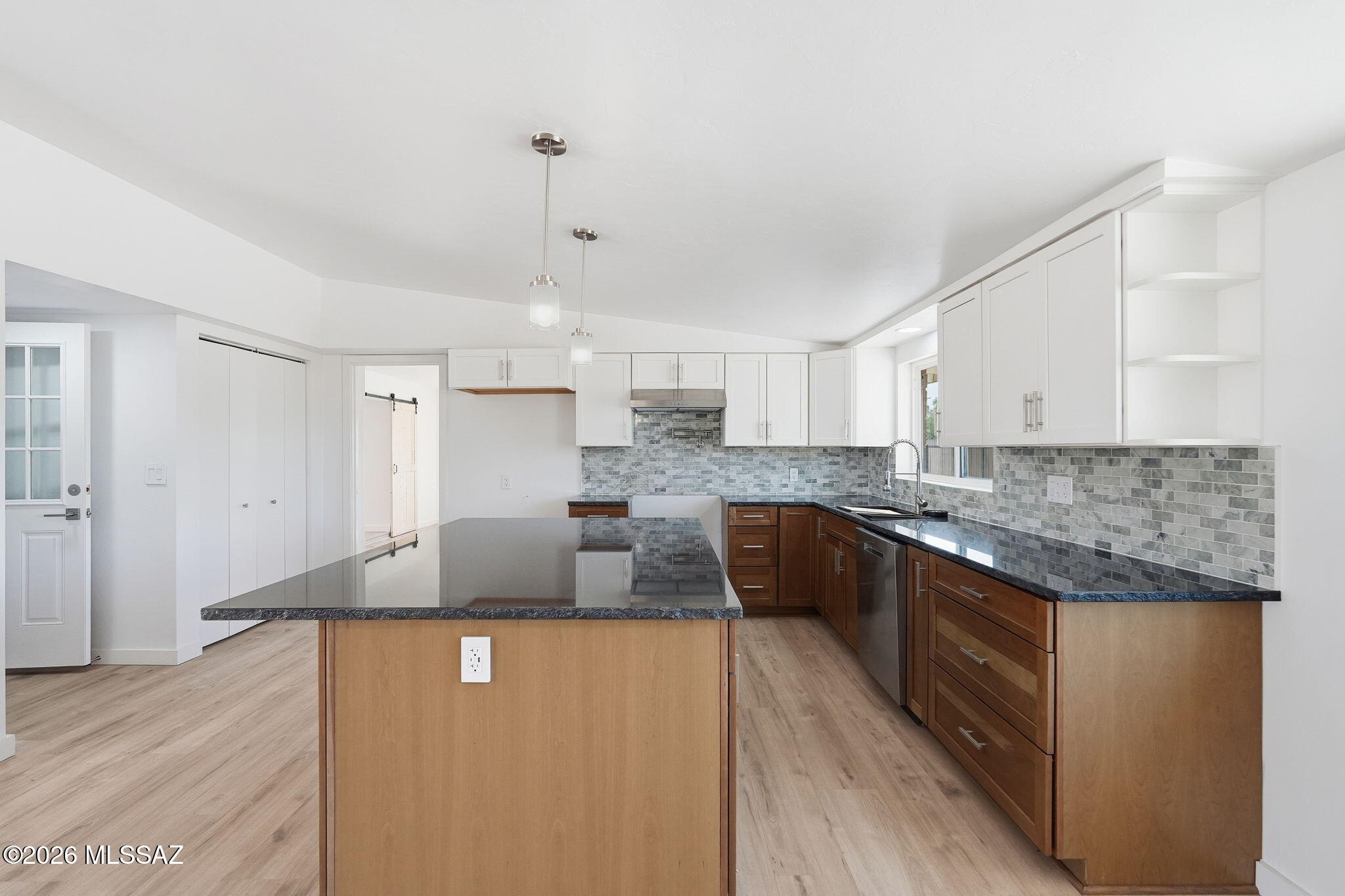 950 West Ina Road Tucson, AZ 85704 - Photo 11 of 54 a large kitchen with granite countertop a sink a counter top space and cabinets