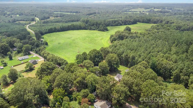 an aerial view of a houses with yard