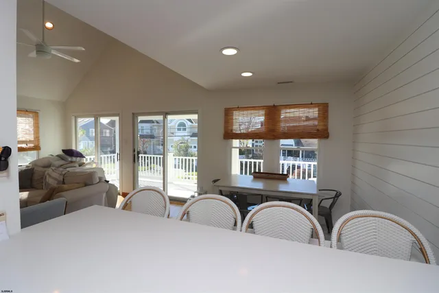 a bedroom with furniture and large windows