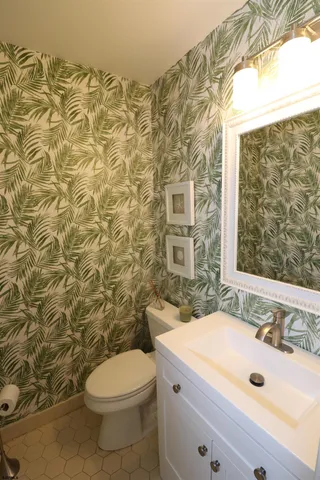 a bathroom with a sink a toilet and shower curtain