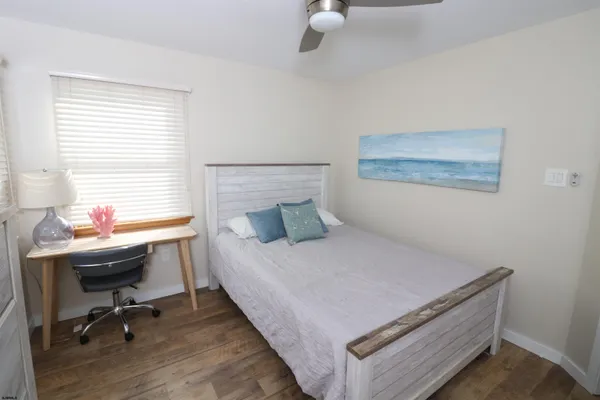 a bedroom with a bed and a desk