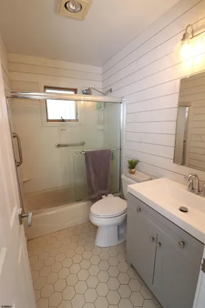 a bathroom with a toilet sink and shower