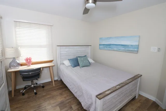 a bedroom with a bed and a desk